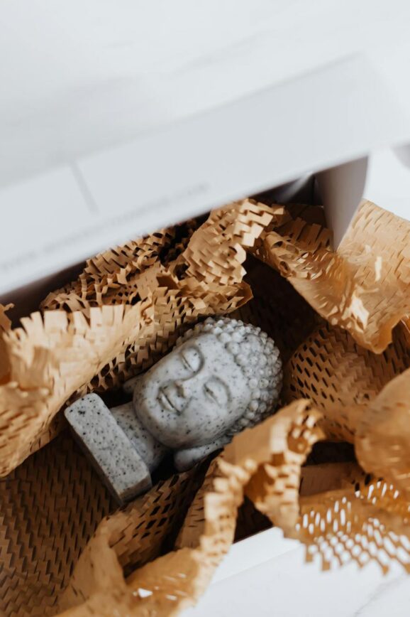granite buddha bust in cardboard package